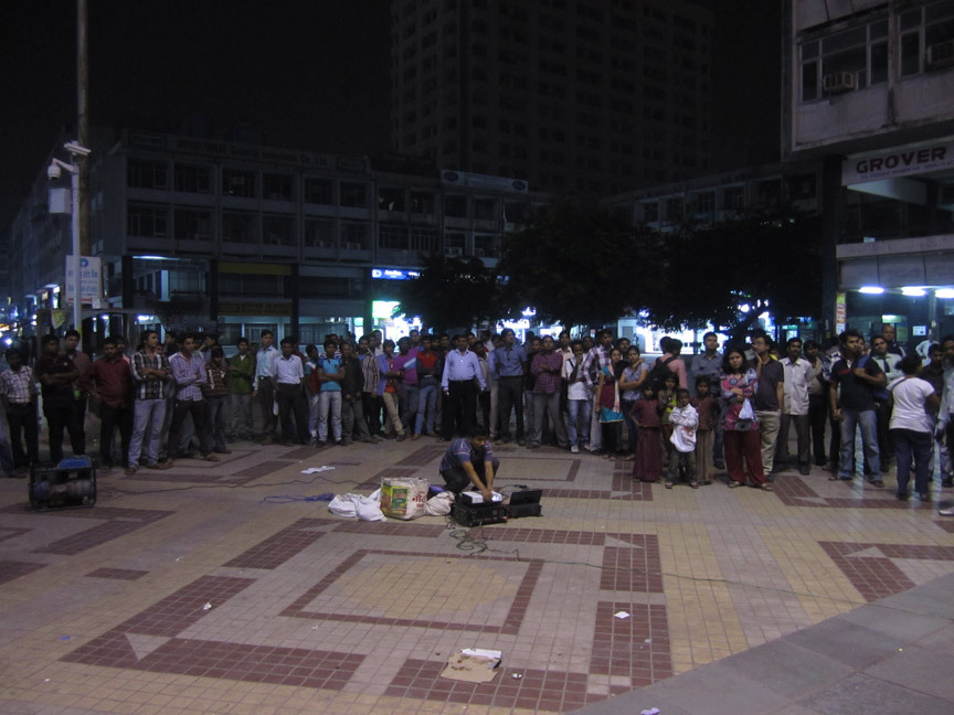 The first site for the screenings is Nehru Place, a commercial IT market named after India’s first Prime Minister. The YLP Film Screening team sets up near Satyam Cinema and immediately a crowd gathers.