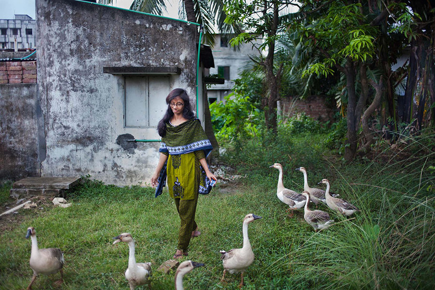 Munira, 21, in the backyard of a neighbor’s house in Dhaka. Munira was attacked with acid at the age of eleven when she refused to accept a love proposal of a man who was 22 years old. In 2003, Munira was sleeping with her mother inside their home in the rural village of Netrokona. At 2 am one night, her attacker broke down the door of the house and threw acid on her. He has never been punished as he was able to bribe authorities to escape penalty. Copyright the artist.