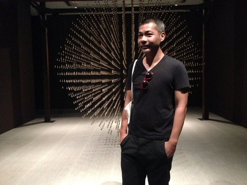 Thai artist ARIN RUNGJANG with his nominated work Golden Teardrop, 2013, at Singapore Art Museum, 2014. Photo by Sylvia Tsai for ArtAsiaPacific.