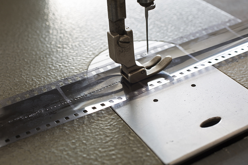 LEUNG CHI WO, Frater (detail), 2015, sewing machine, black-and-white film negative, 50-cent Hong Kong coins from 1967, low speed motor and steel frame, 146.5 × 65 × 55 cm. Courtesy the artist and The Mills Gallery, Hong Kong.