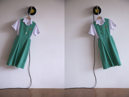 LEUNG CHI WO, A Countess from Hong Kong, Belilios Public School uniform, clothes hanger, 1967 Hong Kong 50-cent coins, vinyl record of This Is My Song (1967) by Petula Clark, motor system, 134 × 68 × 19 cm. Courtesy the artist and Blindspot Gallery, Hong Kong.