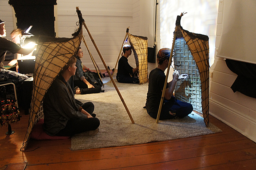 The Sound of Shadows by JUMAADI took place in a 100-year-old heritage building in Sydney’s Middle Head. Two Indonesian performers from Central Java sit at the front playing the bundengans (devices from Wonosobo in Central Java made from woven bamboo), while two audience members sit inside the bundengans behind them. Courtesy Mosman Art Gallery.