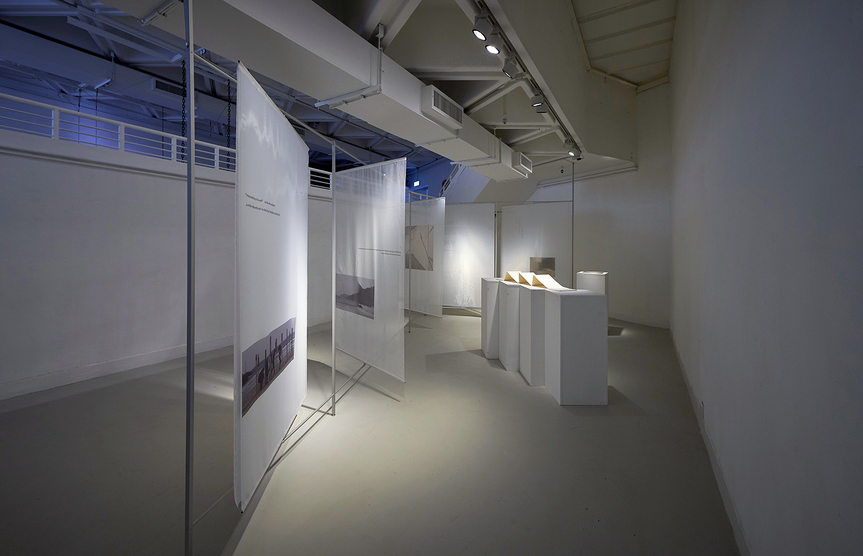 Installation view of CHOI YAN CHI’s Beyond, 2018, photos on white gauze and printed folding booklet, dimensions variable, at “Wan Chai Grammatica: Past, Present, Future Tense,” Hong Kong Arts Centre, 2018.