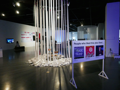 SCOTT KELLY and BEN POLKINGHORNE’s Signs of the Times (2018) billboard (right), and MIKE TYKA’s Portraits of Imaginary People (2017, left).