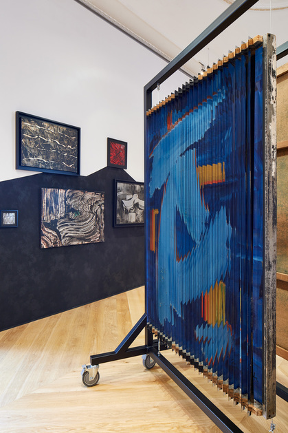 Installation view of BEHJAT SADR’s (foreground, right) Untitled, 1967, oil and aluminum foil on Venetian blinds superimposed on oil on canvas, 150 × 110 cm, at “Dusted Waters,” The Mosaic Rooms, London, 2018. Photograph by Andy Stagg.