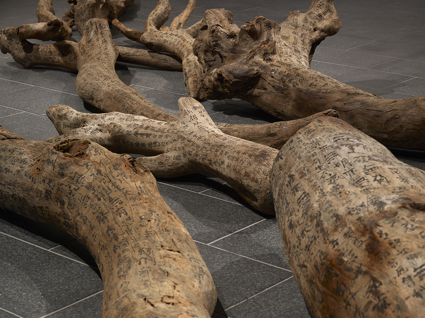 Installation view of CHARWEI TSAI’s Driftwood (detail), 2011, ink on 11 pieces of driftwood, dimensions variable, at “Bulaubulau,” Centre for Chinese Contemporary Art, Manchester, 2018–19. Photo by Michael Pollard. Courtesy the artist and Centre for Chinese Contemporary Art.