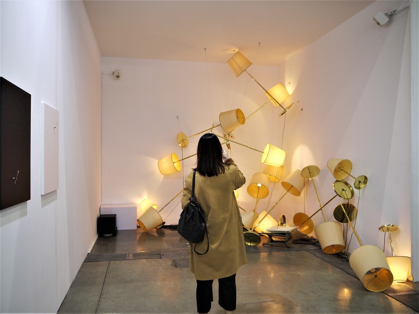 Flickering lampshades form the theatrical Fuzz (2015) by TSUYOSHI HISAKADO at the booth of Ota Fine Arts.