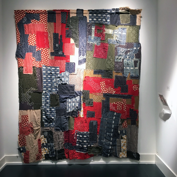 Installation view of MEGUMI SHAUNA ARAI’s Unnamed Lake, 2017–18, new, antique and repurposed textile collected from Japan, United States, and France; natural sashiko thread; seven-channel audio installation, dimensions variable, at “Lore Re-Imagined: Shadows of our Ancestors” at Wing Luke Museum of the Asian Pacific American Experience, Seattle, 2018–19. Courtesy Wing Luke Museum of the Asian Pacific American Experience.