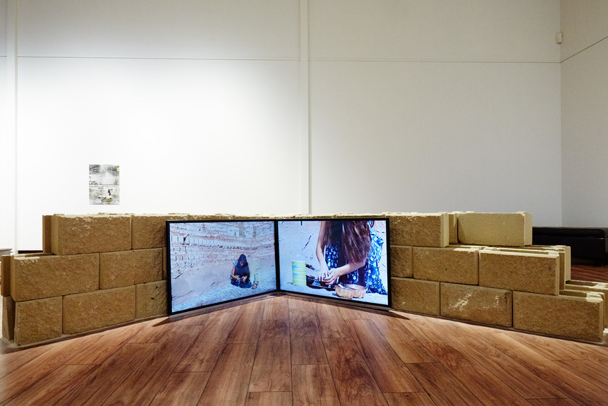 Installation view of JUSTINE YOUSSEF and DUHA ALI’s Kohl, 2018, three-channel video installation, sandstock bricks, video: 4 min, at “Stomping Ground,” Fairfield City Museum & Gallery, Smithfield, 2019. Photo by Josh Morris Photography. Courtesy FCMG.