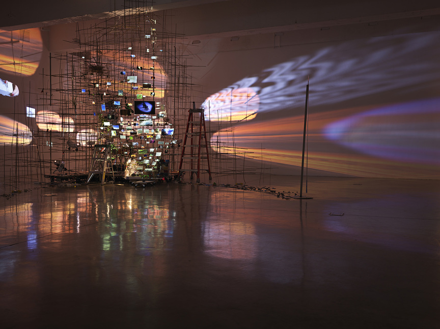 Installation view of SARAH SZE’s Crescent (Timekeeper), 2019, mixed media, wood, stainless steel, acrylic, video projectors, archival pigment prints, ceramic and tape, dimensions variable, at her solo exhibition, Tanya Bonakdar Gallery, New York, 2019.