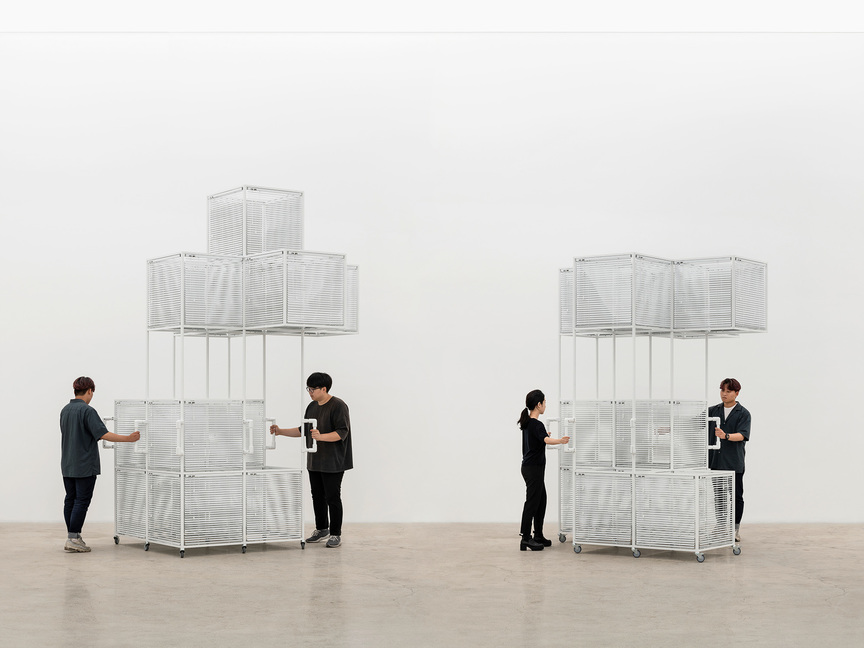 HAEGUE YANG, (left) Sol LeWitt Vehicle – 6 Unit Cube on Cube without a Cube and (right) Sol LeWitt Vehicle – Five Unit Cross on Open Geometric Structure 2-2, 1-1, both 2018, aluminum venetian blinds, powder-coated aluminum frame, powder-coated handles, casters, 362 × 225 × 225 cm and 292 × 222 × 222 cm. Photo by Chunho An. Courtesy the artist and Kukje Gallery, Seoul / Busan.