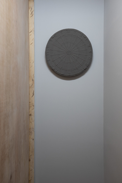 Installation view of KONG CHUN HEI’s Standoff, 2019, dartboard, grinned parts of darts, acrylic matte medium, plastic parts of darts, dimensions variable, at “Raise the Dimness,” TKG+, Taipei, 2020.